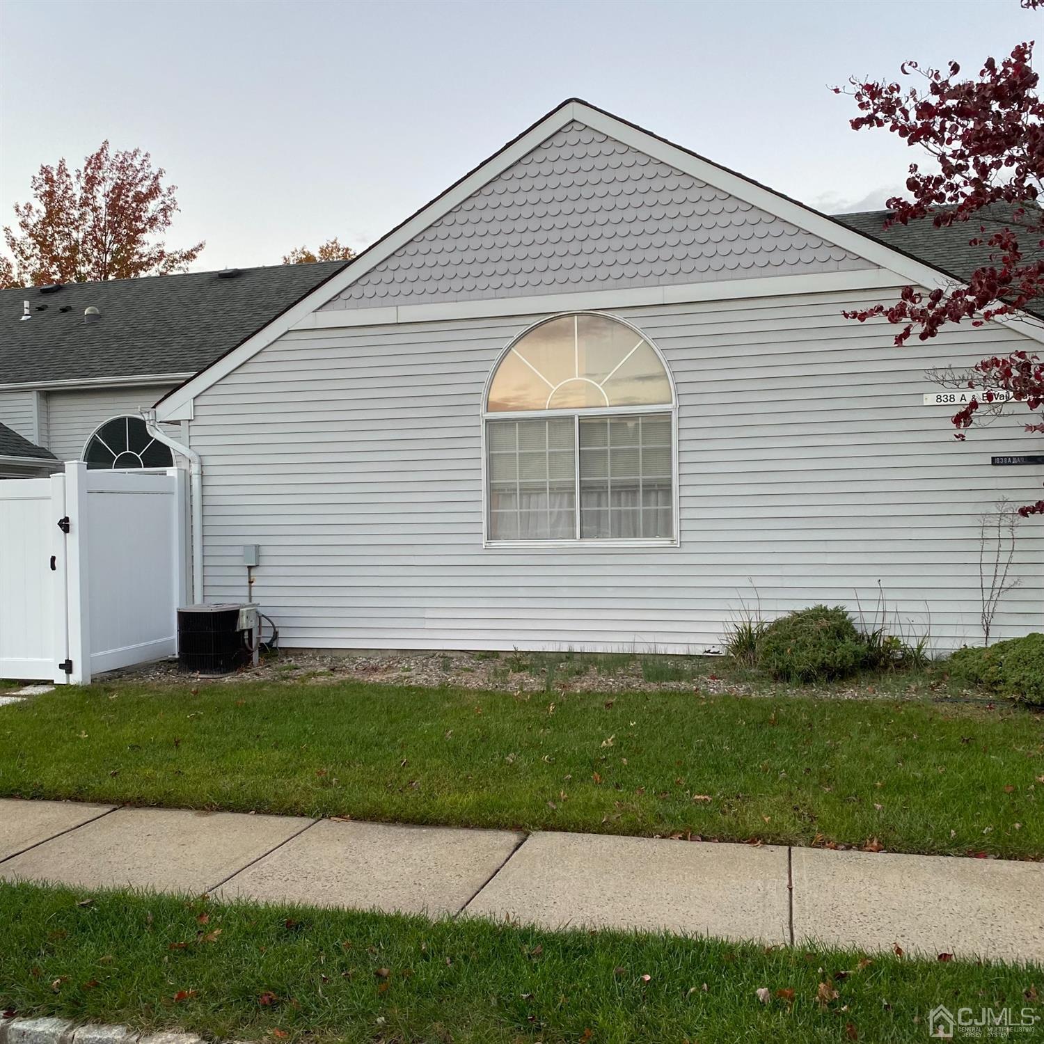 838 Vail Road, Unit A Monroe Township, NJ 08831 - Photo 2 of 16 a front view of a house with a yard