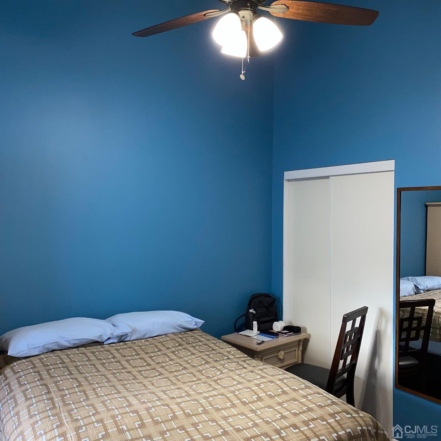 838 Vail Road, Unit A Monroe Township, NJ 08831 - Photo 12 of 16 a bedroom with a bed and a lamp on dresser