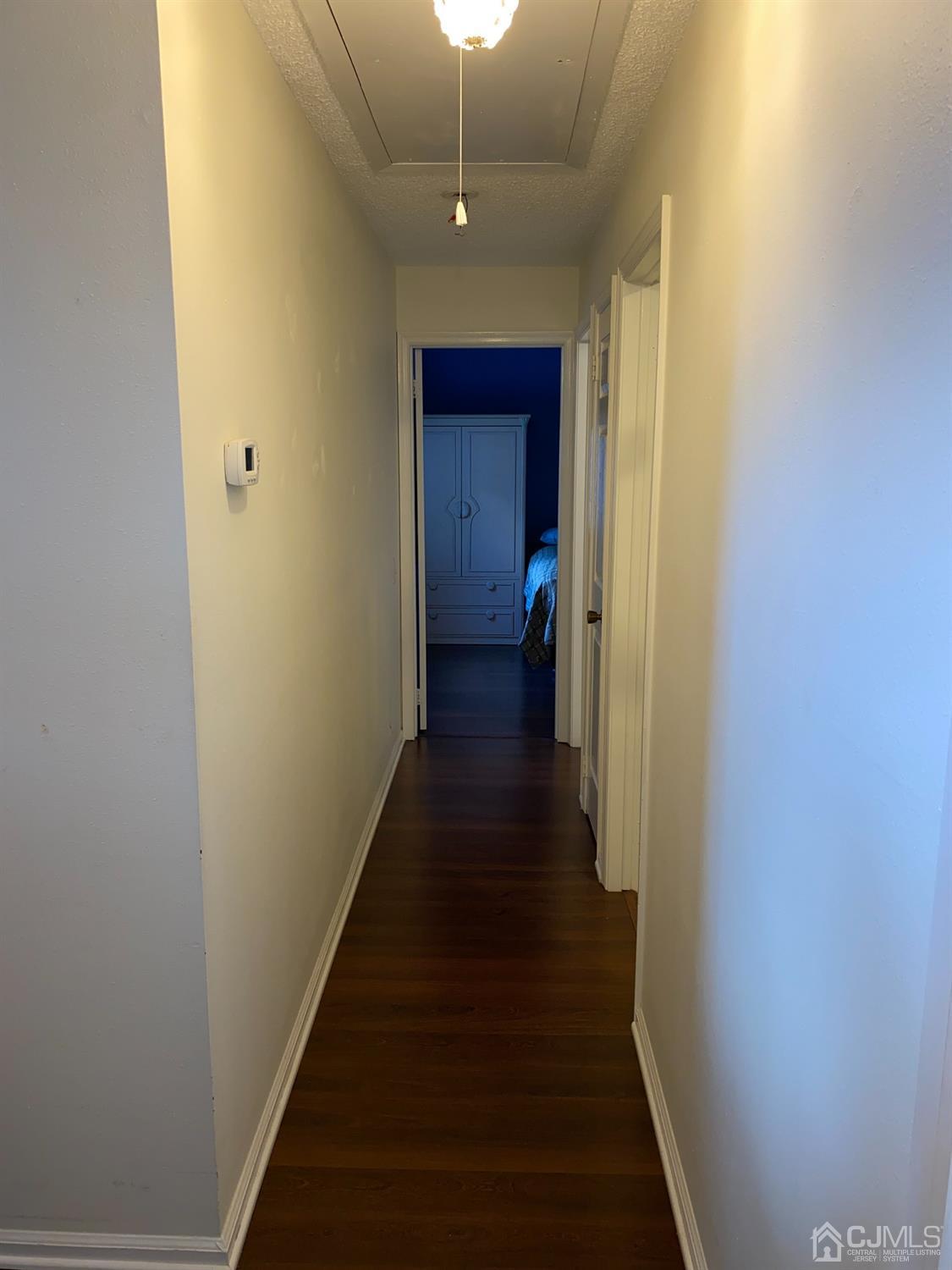 838 Vail Road, Unit A Monroe Township, NJ 08831 - Photo 15 of 16 a view of a hallway with wooden floor
