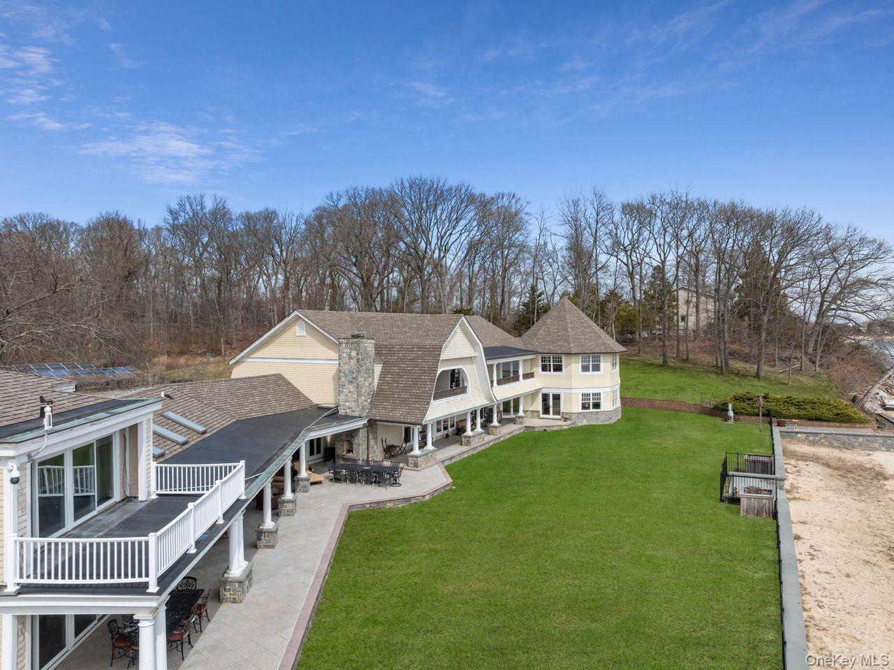 33 Beach Road Northport, NY 11768 - Photo 44 of 50 a front view of a house with a garden and trees