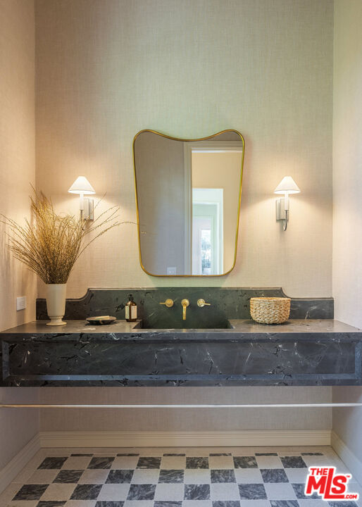 15620 Woodvale Road Encino, CA 91436 - Photo 19 of 37 a bathroom with a granite countertop sink and a mirror