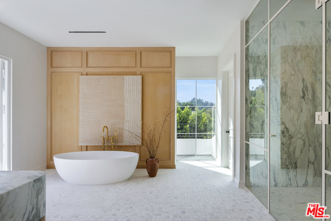 15620 Woodvale Road Encino, CA 91436 - Photo 24 of 37 a bathroom with a tub and shower