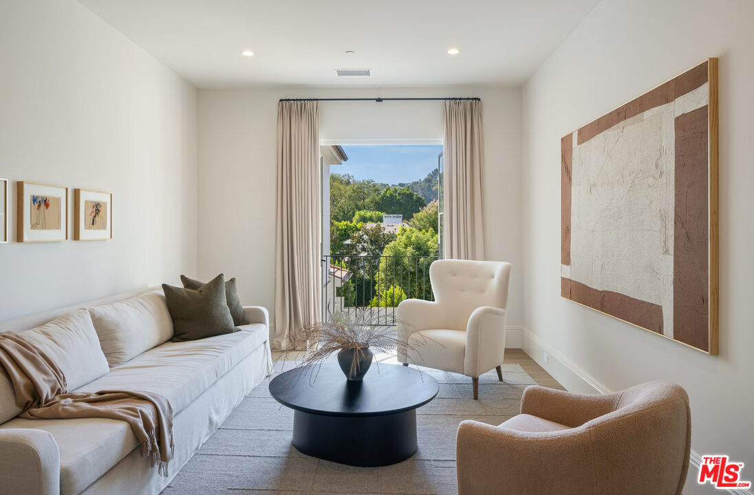 15620 Woodvale Road Encino, CA 91436 - Photo 27 of 37 a living room with furniture and a large window