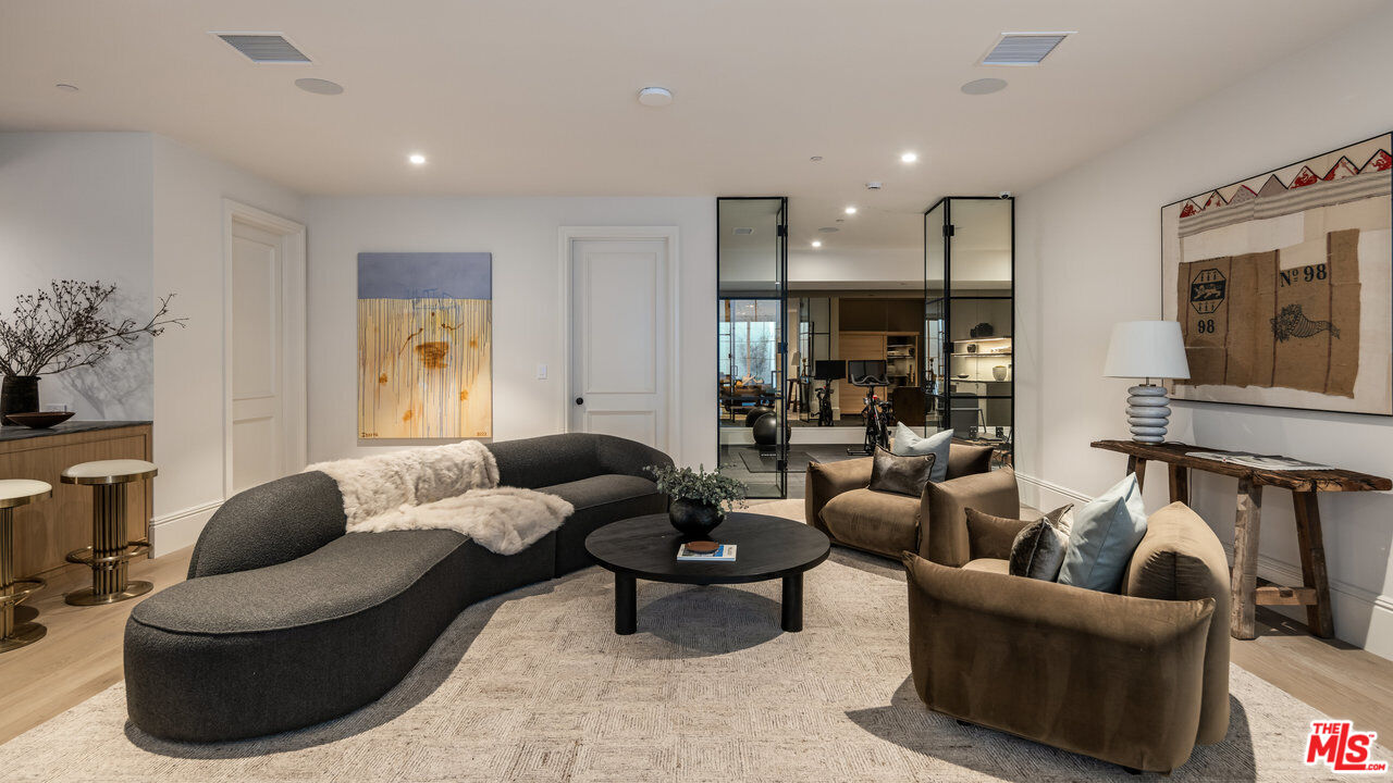 15620 Woodvale Road Encino, CA 91436 - Photo 34 of 37 a living room with furniture and a large window
