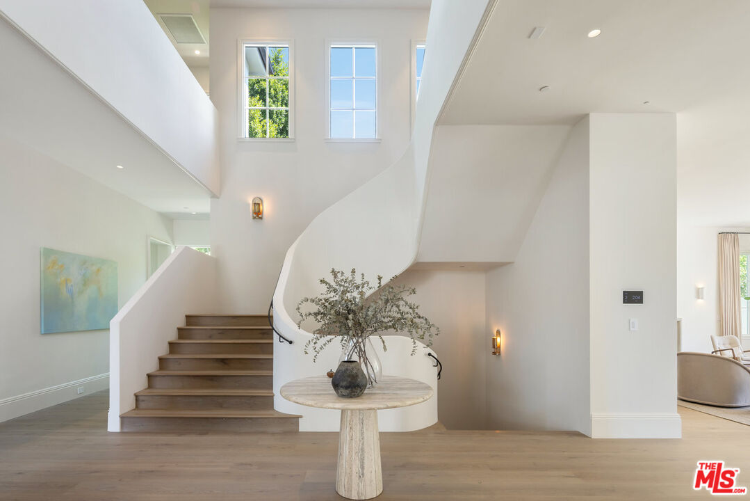 15620 Woodvale Road Encino, CA 91436 - Photo 8 of 37 a view of entryway and hall with wooden floor