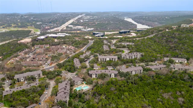 a view of a patio with table and chairs potted plants with wooden floor and fence