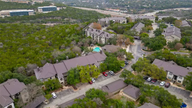 an aerial view of residential houses with outdoor space