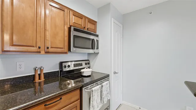 a kitchen with granite countertop a stove and a sink
