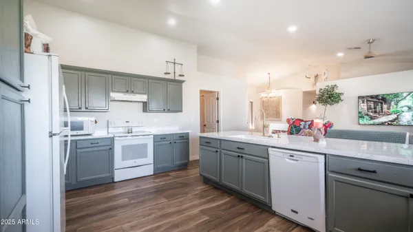 a kitchen with a sink cabinets stainless steel appliances and a window