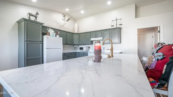a kitchen with refrigerator and microwave