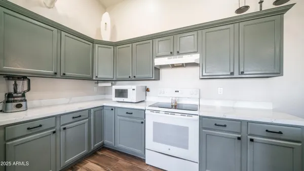 a kitchen with stainless steel appliances granite countertop a sink a stove and cabinets