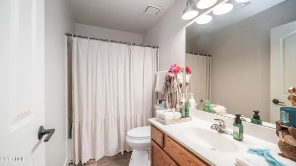a bathroom with a sink vanity mirror and toilet
