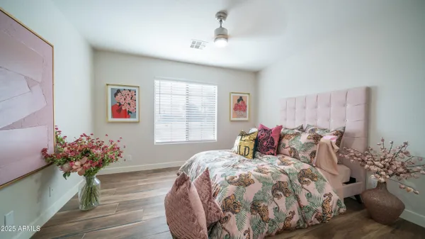 a bed sitting in a bedroom next to a window