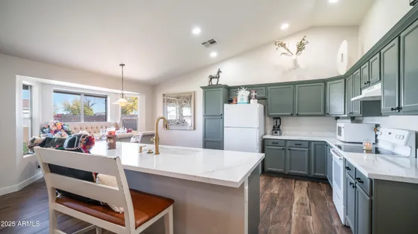 a kitchen with a sink a counter space appliances and cabinets