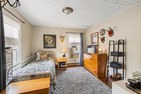 a bed room with furniture and a flat screen tv