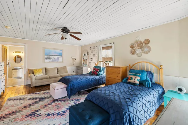 a bedroom with two beds and a chandelier