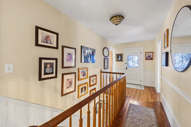 a view of a hallway with paintings on the wall