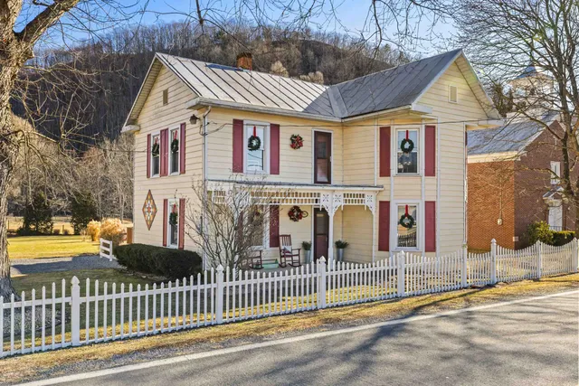 a front view of a house with a garden and plants