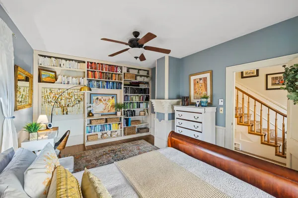a bedroom with furniture and a book shelf