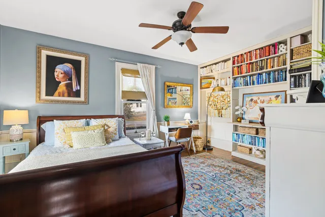 a living room with furniture and a book shelf