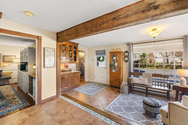 a living room with furniture and a open kitchen view