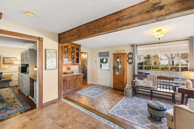 a living room with furniture and a open kitchen view