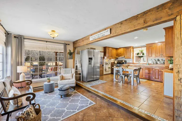 a living room with lots of furniture and a view of kitchen