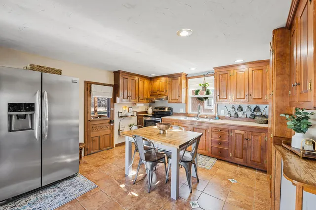 a dining room with a table and chairs with wooden floor