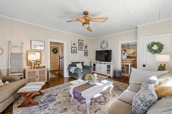 a living room with furniture or couch and a chandelier
