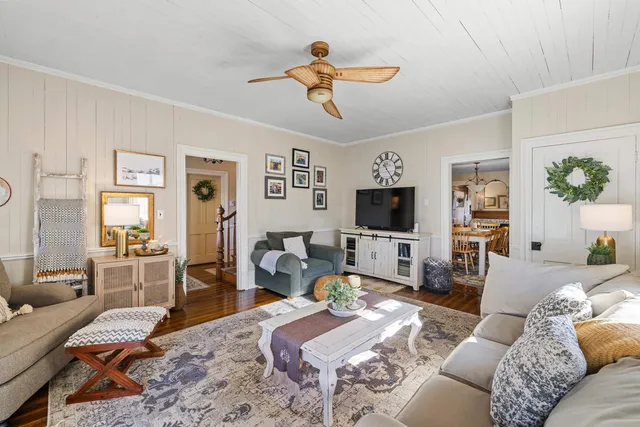 a living room with furniture or couch and a chandelier