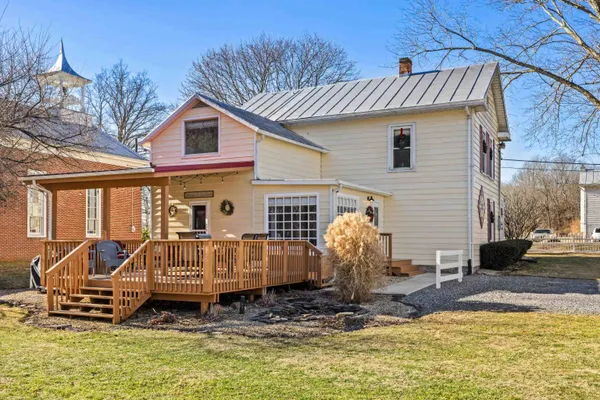 a view of a swimming pool with sitting area and furniture
