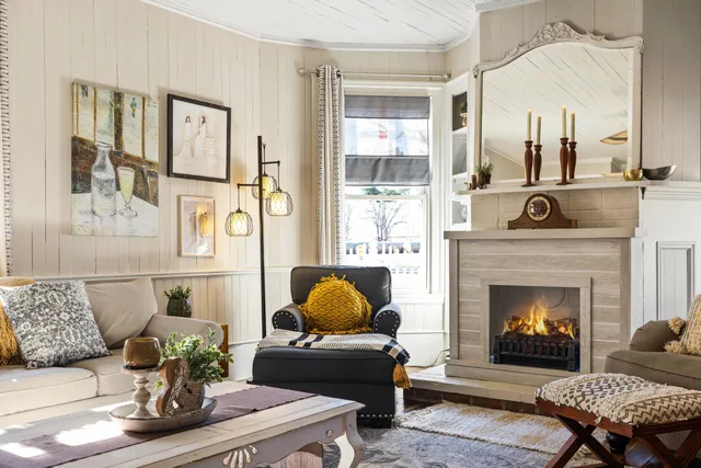 a living room with furniture and a fireplace