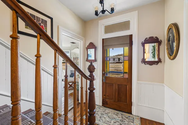 a view of an entryway with wooden floor and stairs