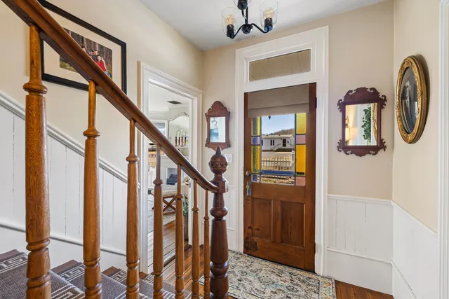 a view of an entryway with wooden floor and stairs