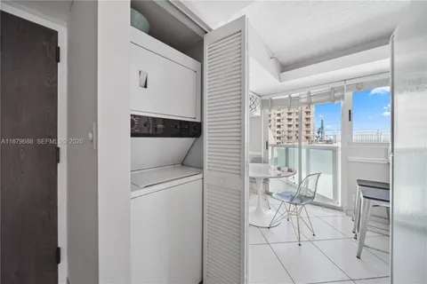 a kitchen with a refrigerator and table