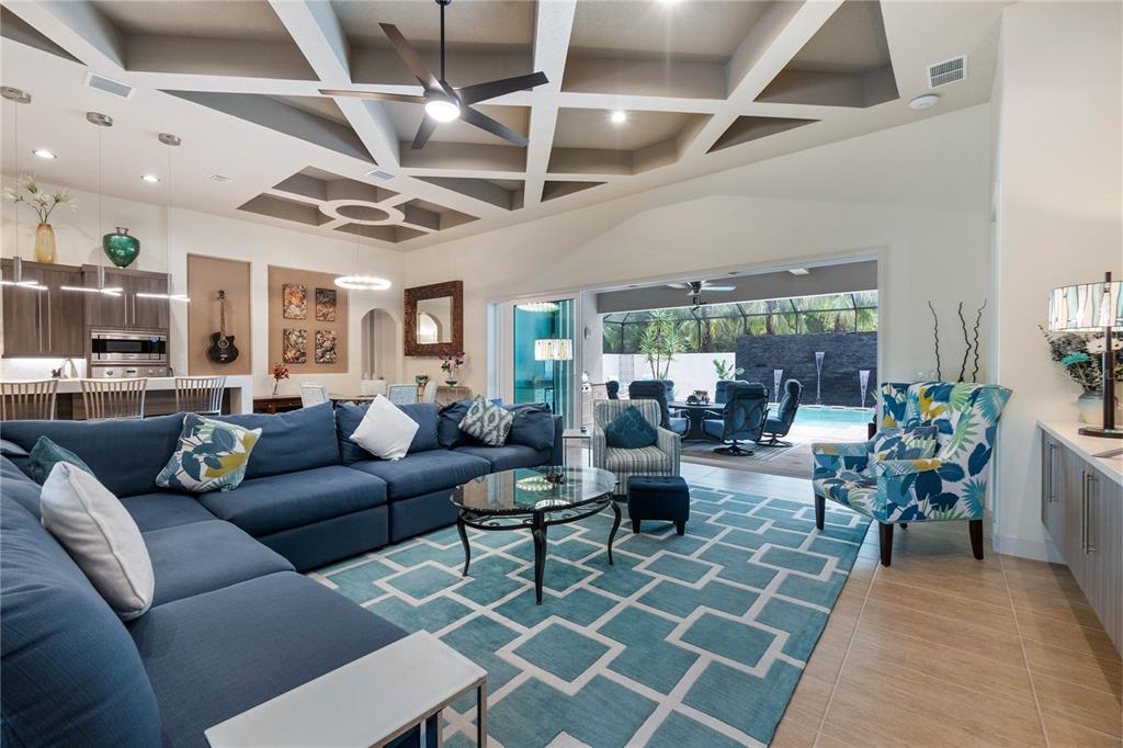 a living room with furniture and a chandelier