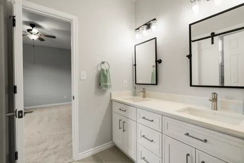 a bathroom with a sink a toilet and a mirror