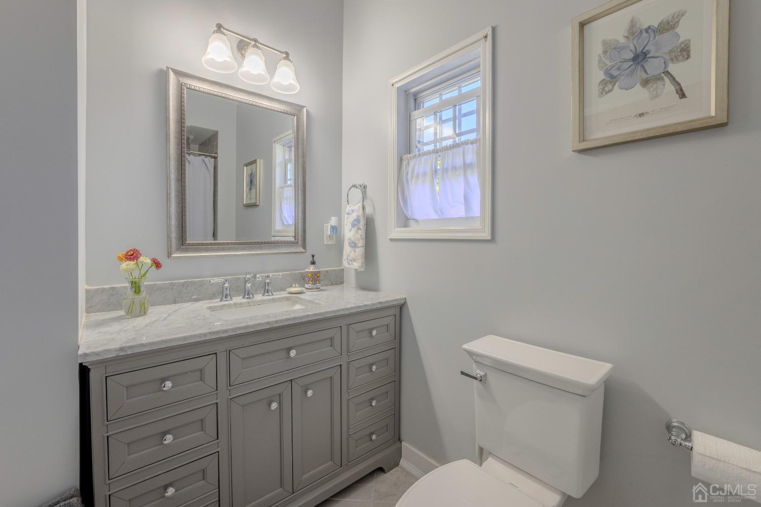314 Walnut Street Dunellen, NJ 08812 - Photo 17 of 48 a bathroom with a toilet a sink and mirror