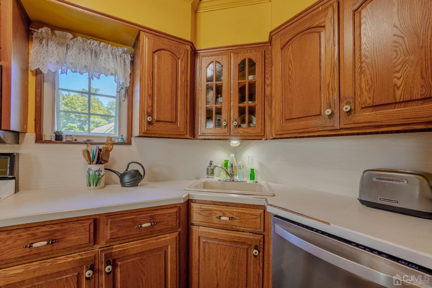 314 Walnut Street Dunellen, NJ 08812 - Photo 18 of 48 a kitchen with stainless steel appliances granite countertop a sink and cabinets with wooden floor