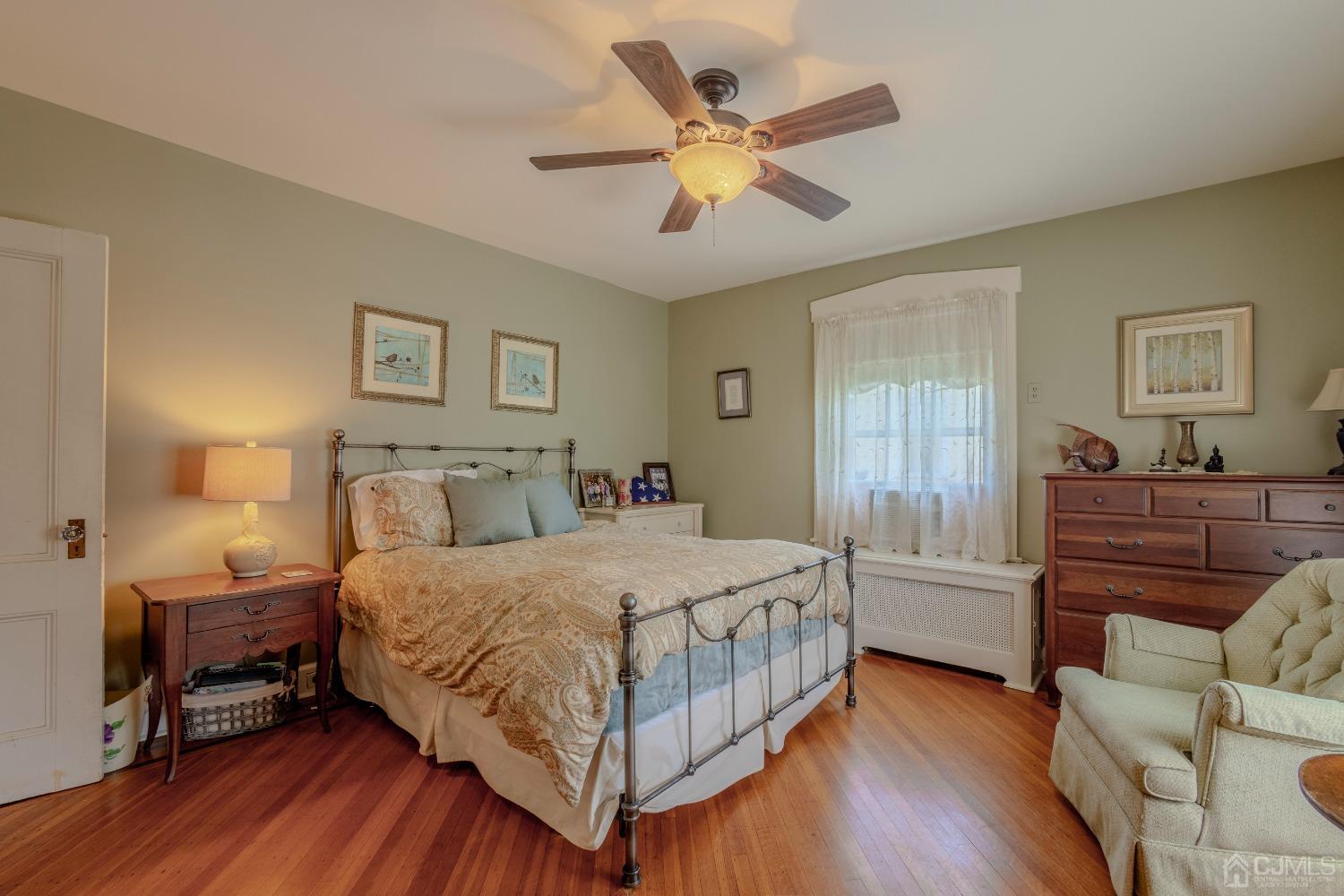 314 Walnut Street Dunellen, NJ 08812 - Photo 24 of 48 a bedroom with a bed and wooden floor