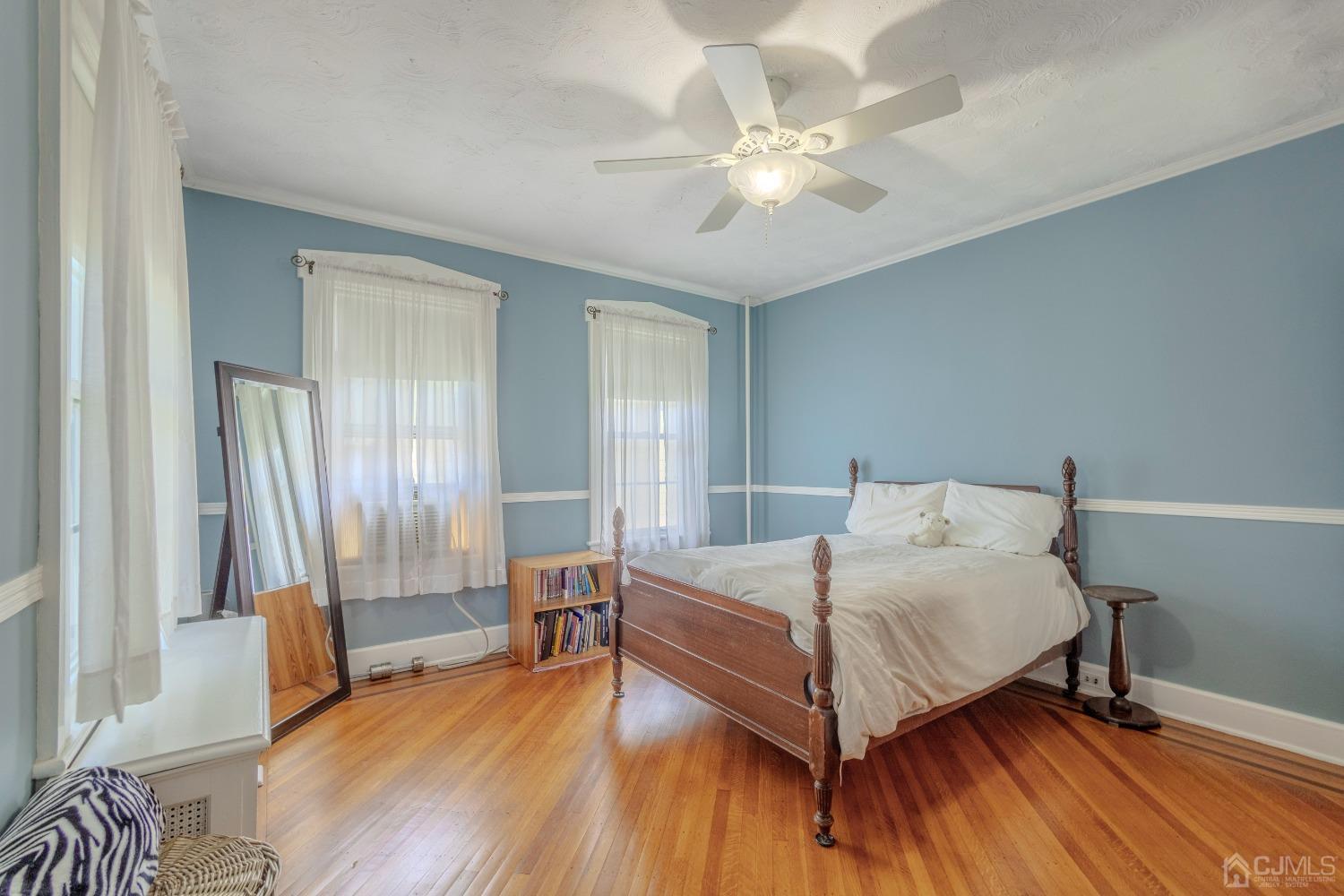 314 Walnut Street Dunellen, NJ 08812 - Photo 26 of 48 a bedroom with a bed and a chandelier