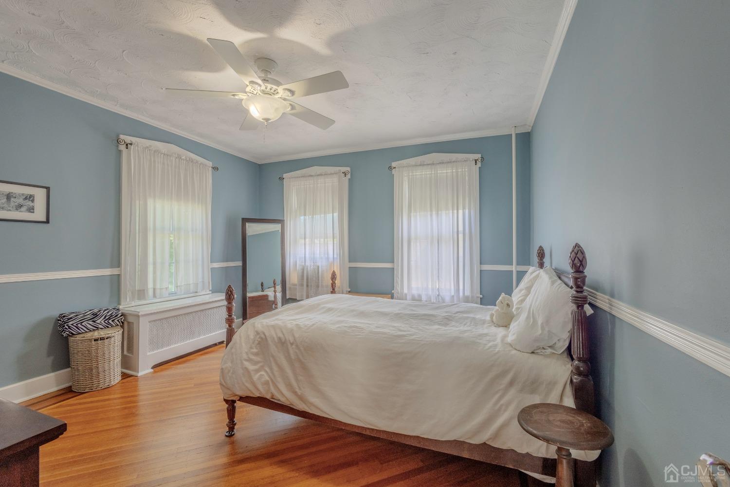 314 Walnut Street Dunellen, NJ 08812 - Photo 27 of 48 a spacious bedroom with a bed and a chandelier