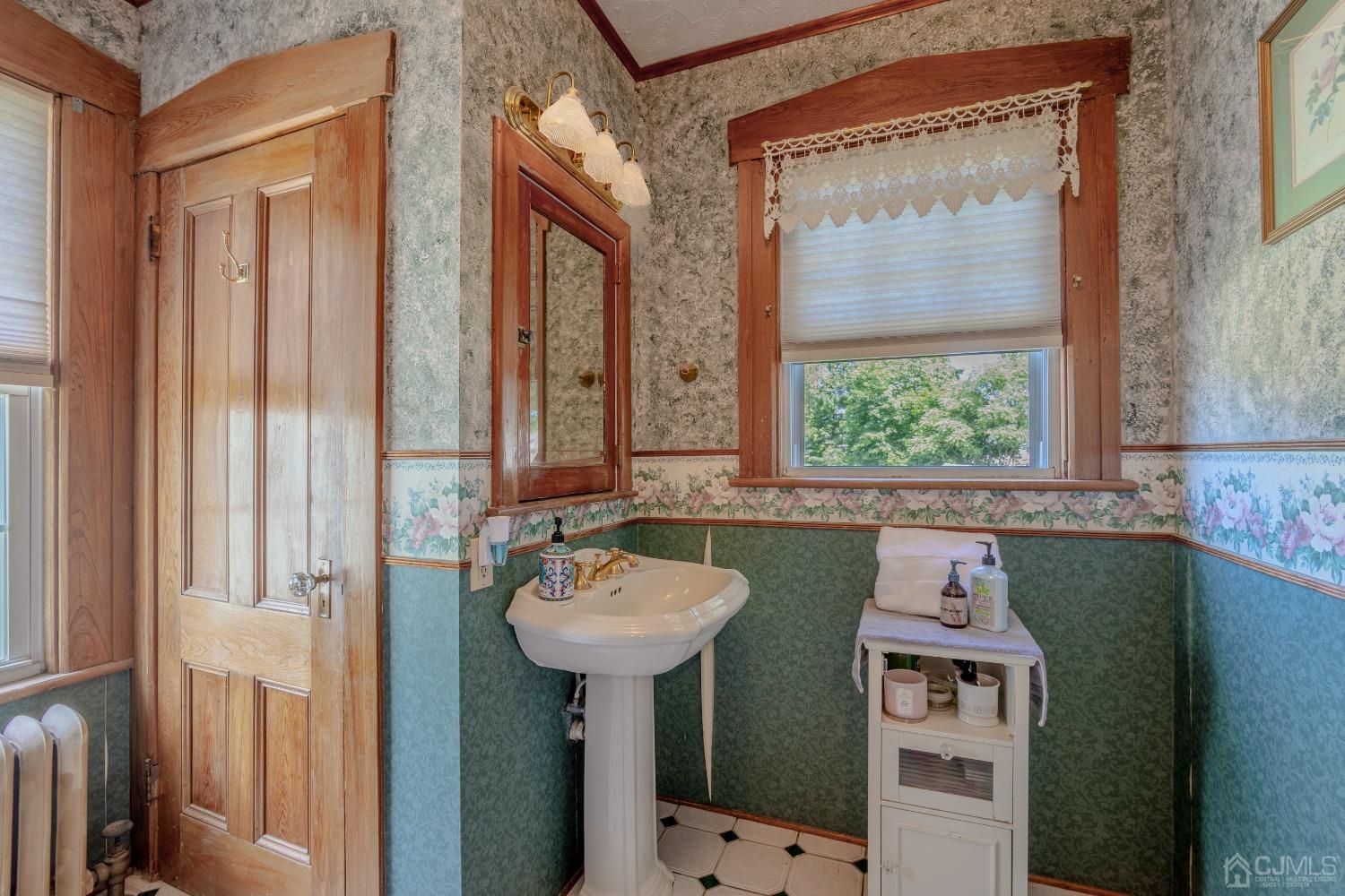 314 Walnut Street Dunellen, NJ 08812 - Photo 32 of 48 a bathroom with a sink a mirror and a window