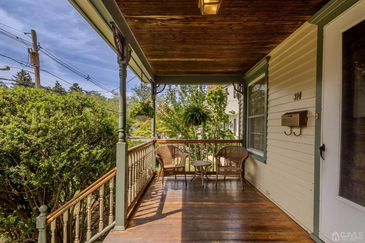 314 Walnut Street Dunellen, NJ 08812 - Photo 4 of 48 a balcony with chairs and wooden floor