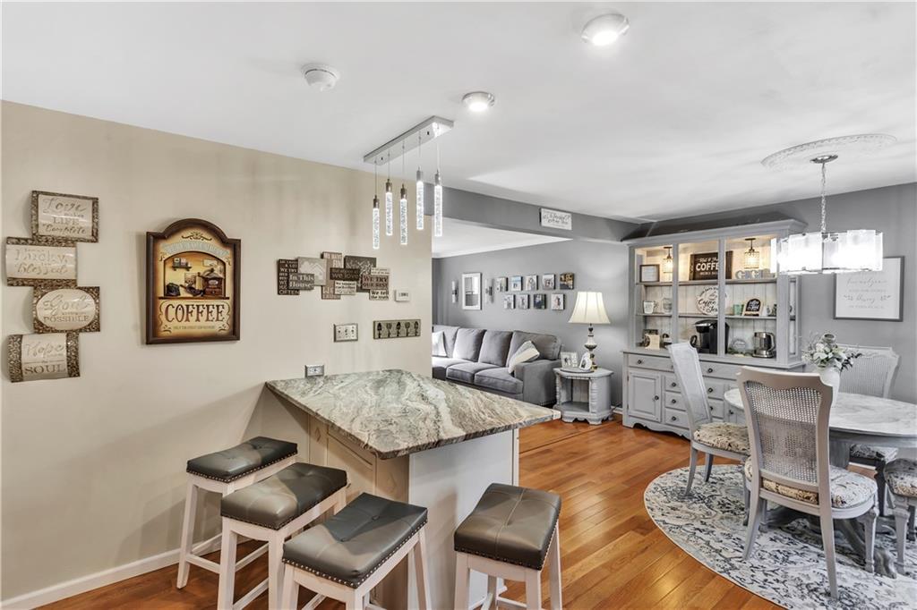 9 Quail Court Export, PA 15632 - Photo 17 of 35 Open Concept Kitchen / Dining with Gorgeous Lighting and Leathered Granite Breakfast Bar/Peninsula.