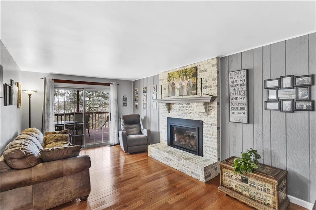9 Quail Court Export, PA 15632 - Photo 22 of 35 Wood Floors Continue into the 18x11 Family Room with White Washed Brick Fireplace and Slider to Covered Rear Deck.