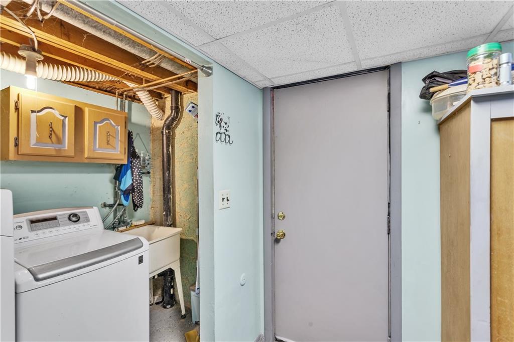 9 Quail Court Export, PA 15632 - Photo 34 of 35 11x7 Laundry Area with Utility Sink Off Storage Room in Basement (Washer/Dryer NOT Included). Walkout Door to Rear Patio and Yard.