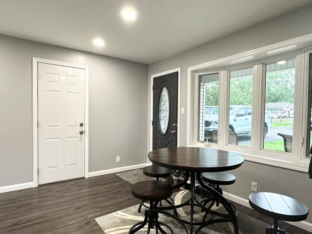 a view of a dining room with furniture window and outside view