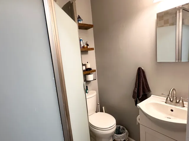 a white toilet sitting next to a bathroom sink