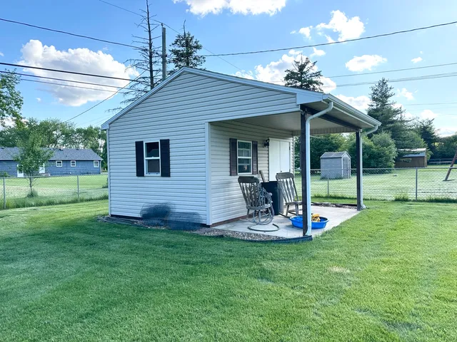 a view of a house with backyard and a slide